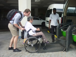 Guest with Caretaker assisted into  Van with Automatic Wheelchair lift